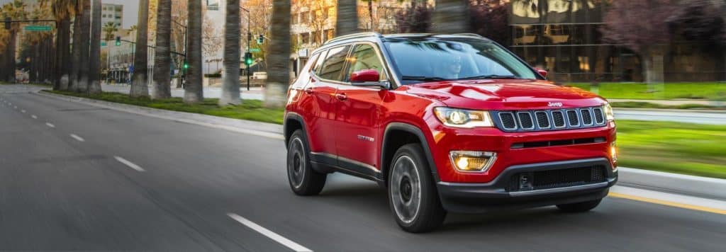 Red Jeep Driving down road