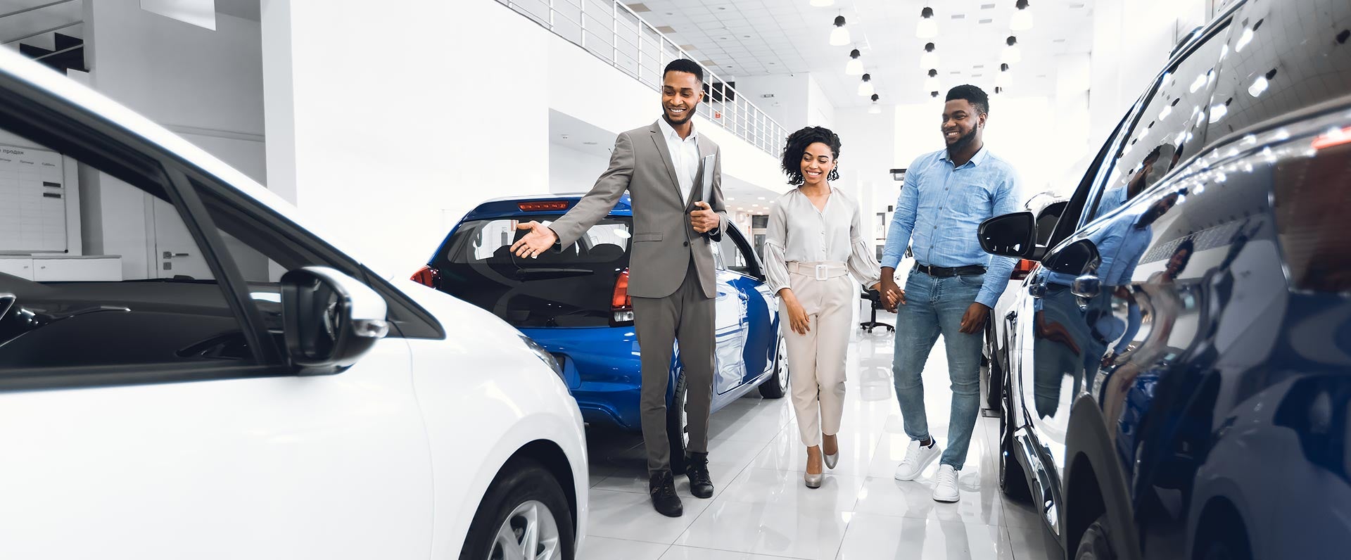 Car salesman showing vehicle to couple